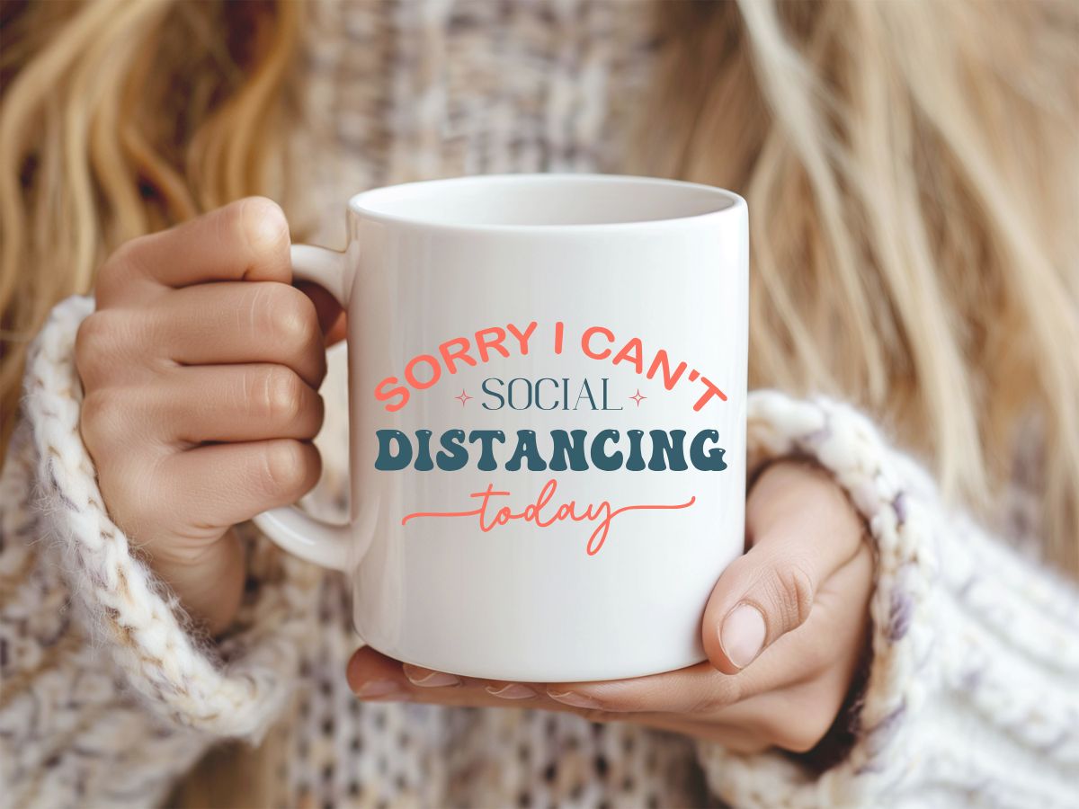Person holding a mug with text 'Sorry I can't social distancing today'.