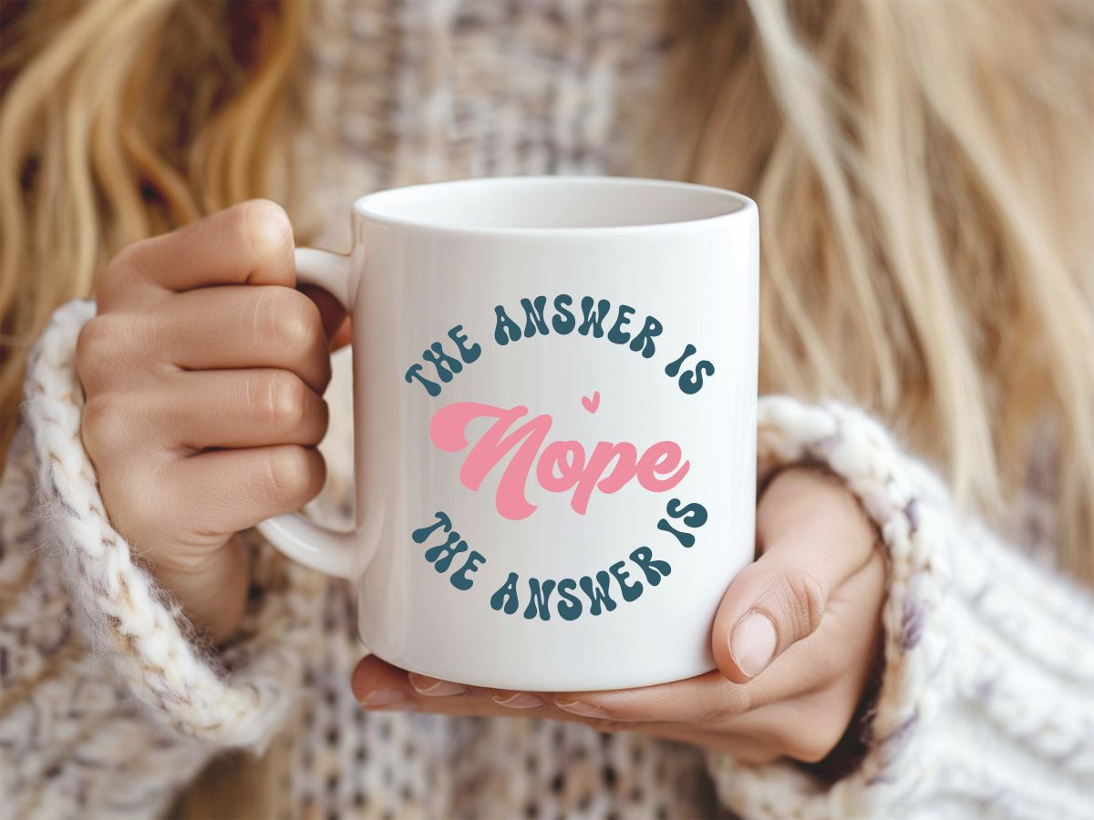 Person holding a mug with 'The answer is hope' text