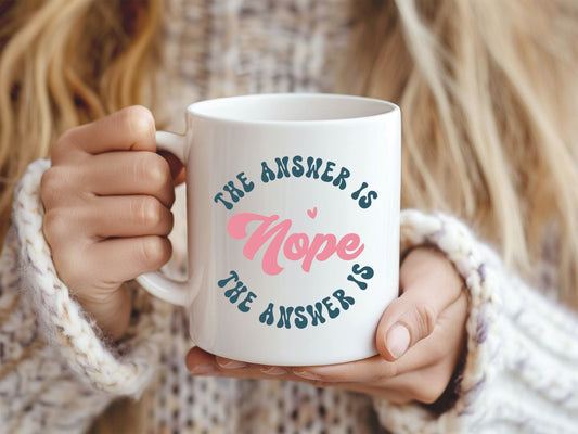 Person holding a mug with 'The answer is hope' text