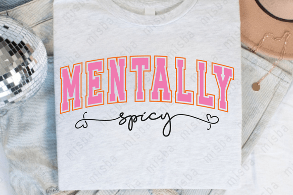 White tee with 'MENTALLY spicy' text in pink and black on a wooden surface.